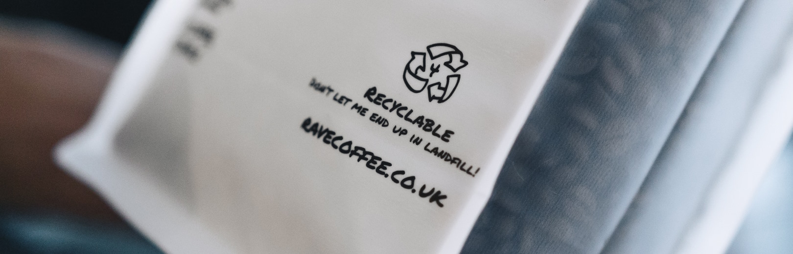 A recyclable logo on roasted coffee packaging.