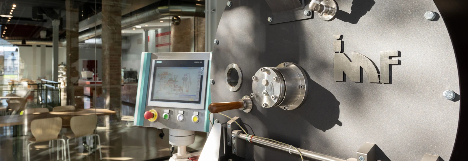A close-up of an IMF machine in a roastery café.